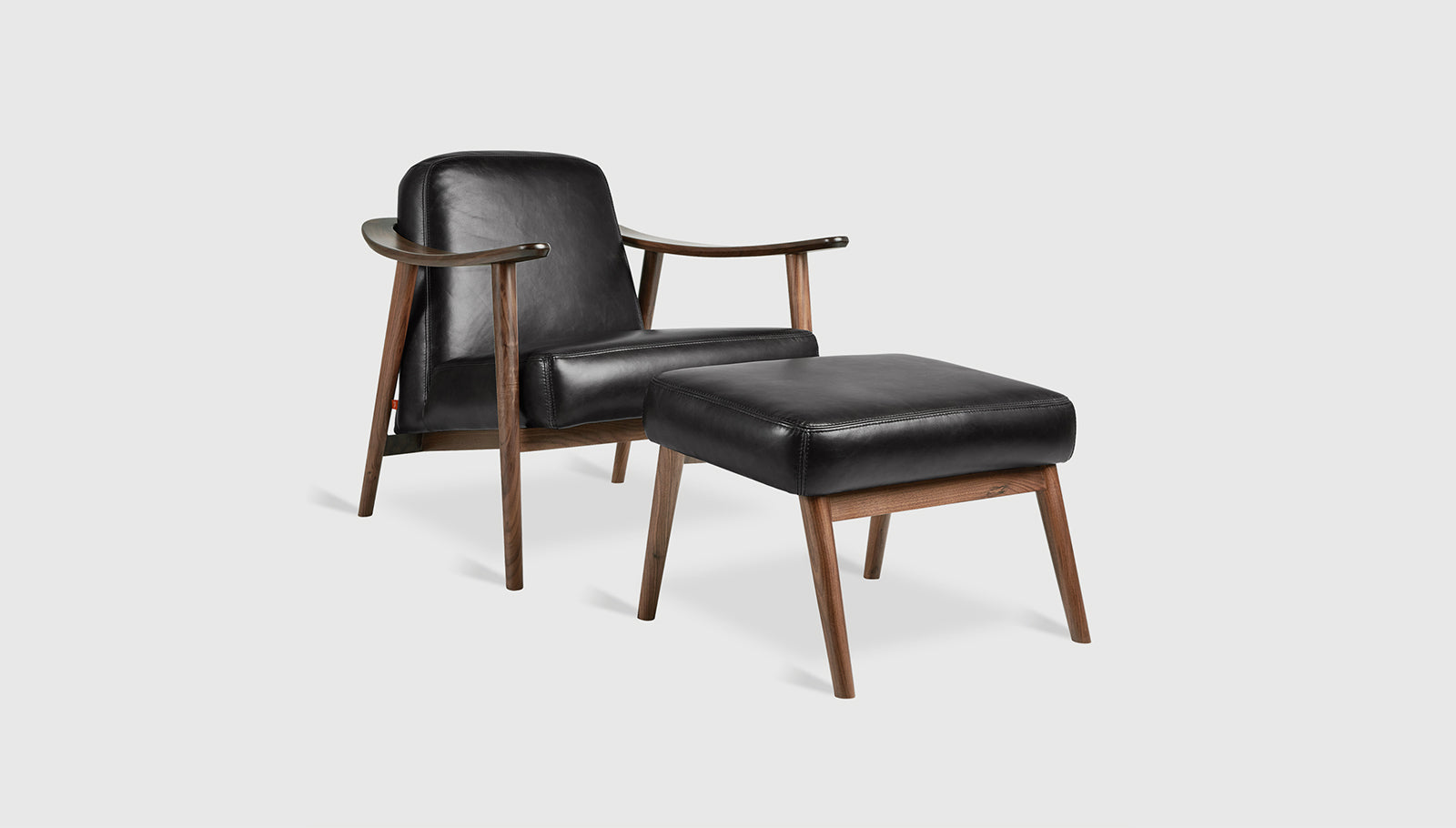 Baltic Chair & Ottoman Saddle Black Leather / WalnutChair & Ottoman Gus*  Saddle Black Leather Walnut  Four Hands, Mid Century Modern Furniture, Old Bones Furniture Company, Old Bones Co, Modern Mid Century, Designer Furniture, https://www.oldbonesco.com/